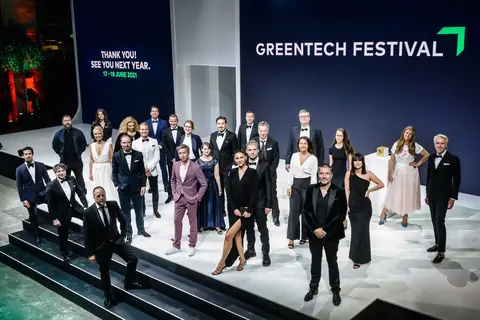 The full festival team on stage under a GREENTECH FESTIVAL screen at the close of the 2020 edition