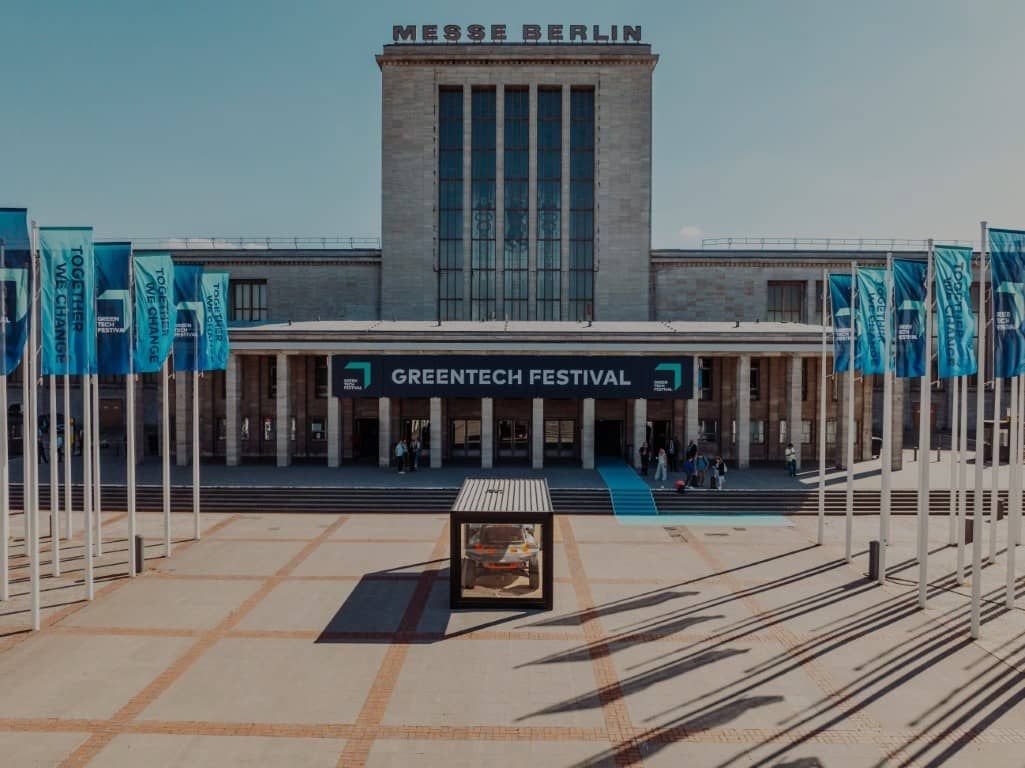 The Messe Berlin entrance dressed for GREENTECH FESTIVAL 2024, lined with festival flags